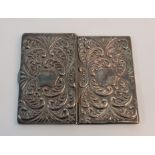 A card case of rectangular form with repousse scroll design, stamped 925.