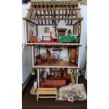 A hand made dolls house the greengrocers shop fitted with furniture on all three floors approx