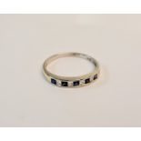 A rubbed marked white metal sapphire and diamond half eternity ring, ring size S