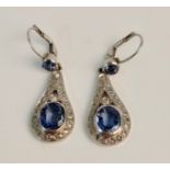 A pair of white metal blue sapphire and diamond dropper earrings, each earring approx. total carat