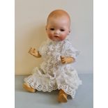 A German Armand Marseille porcelain head doll with composite body.