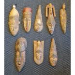 Eight carved wood African tribal masks painted.