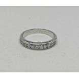 A Tiffany & Co Lucida diamond half eternity ring, set with eleven Lucida cut diamonds, total diamond