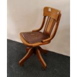 An oak swivel office chair.