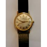 A gents gold plated Zenith wrist watch, the champagne dial having hourly baton markers, reverse case