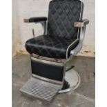 *A black and chrome hydraulic barber chair without head rest.