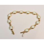 A stamped 585 opal link bracelet of 11 opals, approx. length 18cms