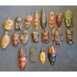 A box containing a quantity of carved wood African tribal masks.