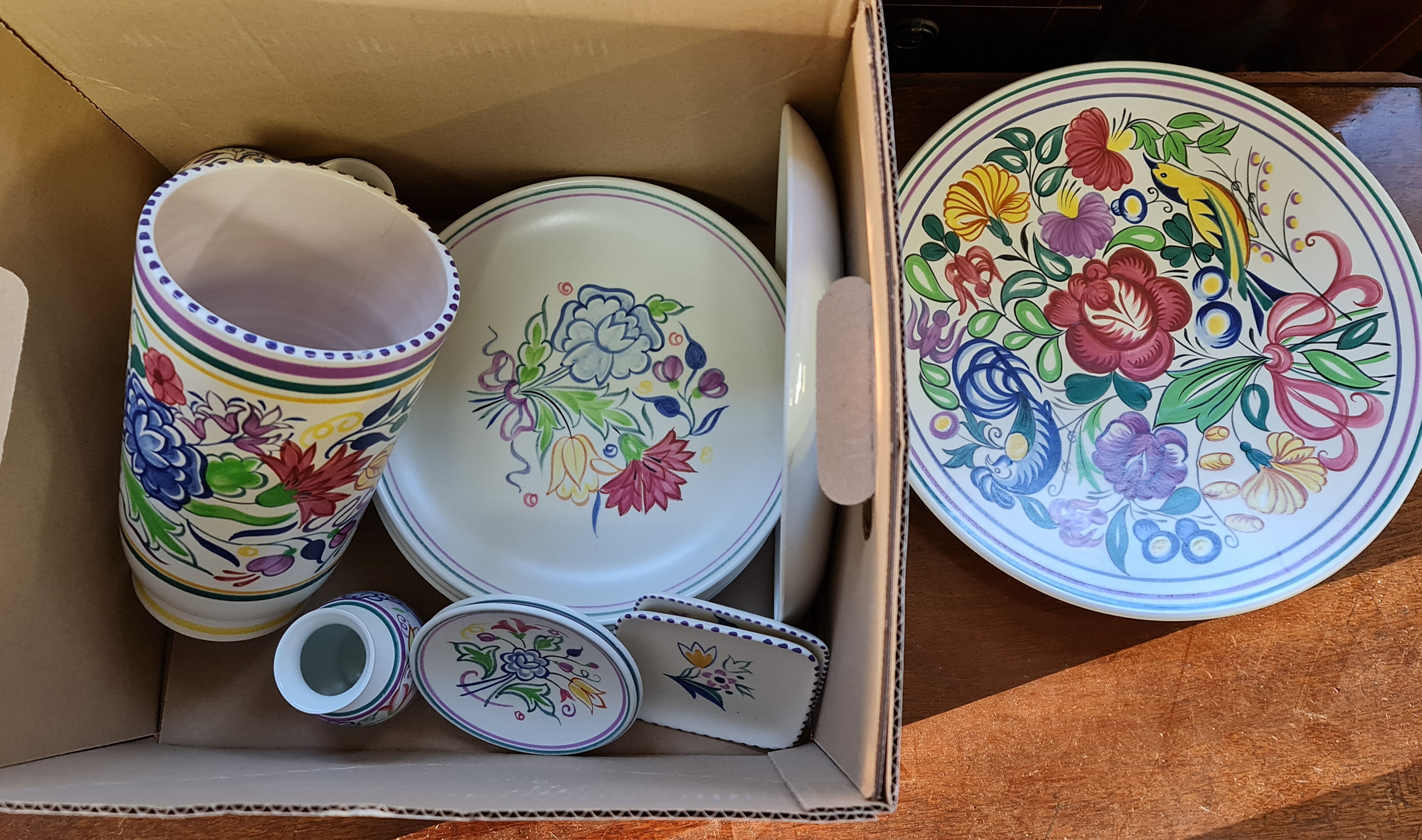 A collection of Poole pottery vases and plates.