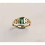 A stamped 9k emerald ring with diamond accents either side, ring size M 1/2,