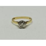 A hallmarked 18ct yellow gold diamond solitaire ring, illusion set with a round brilliant cut