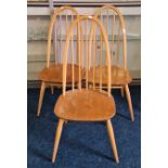 Three Ercol stick back dining chairs.