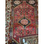 A Persian style red rug with bird border 170 cm 112 cm approx.