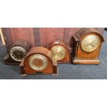 Four mantle clocks with domed tops.