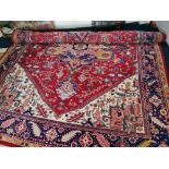 A large Afghan style red pink and blue rug 450 cm 345 cm approx.