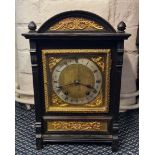 An oak cased mantle clock with brass fittings.