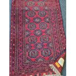 A red and dark blue Afghan rug 200 cm 106 cm approx.
