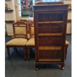 A set of six oak dining chairs together with a oak glazed door bookcase.