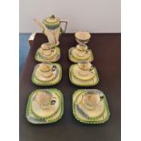 A art deco twenty piece Burleigh Ware coffee set grey tree and green border design.