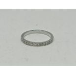 WITHDRAWN. A Tiffany & Co. hallmarked platinum diamond half eternity ring, set with 17 round