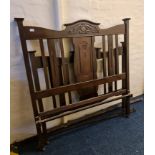 A 4-6 walnut carved bed frame.