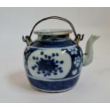 A 19th century Chinese blue and white teapot blossom design with metal handles height 9,5 cm.