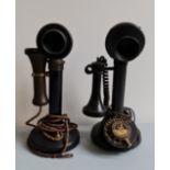 Two black stick telephones.