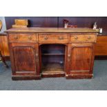 A 19th century mahogany three drawer sideboard base with two cupboard doors.