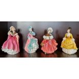 Four Royal Doulton figures to include The Skater, and Spring Morning.