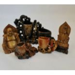 A collection of soapstone Buddhas and brush stands.