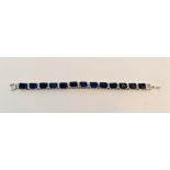 An articulated bracelet of 13 blue stones each one separated by double gem stones .approx. length