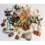 A collection of costume jewellery, to include pendants and chains, brooches, bangles, beads,