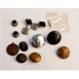 A collection of buttons, a pair of black stone cufflinks, and tie studs