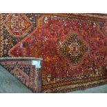 A Persian style red and blue rug with floral border 270 cm 160 cm approx.