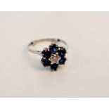 A sapphire and diamond seven stone cluster ring, assessed as 18ct, ring size K