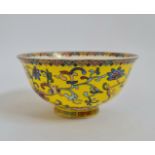 A Chinese yellow glazed bowl with square border to foot flower design with six character marks to