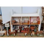 A hand made dolls house Ship inn pub with furniture on two floors stable and front approx height