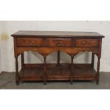 A oak three drawer dresser base with turned columns height 89 cm.