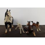 A Beswick Pinto pony a dapple foal and two brown foals.