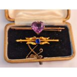 Two yellow metal gem stone bar brooches, (one with safety chain), one with amethyst heart shaped
