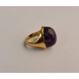 An amethyst cabochon ring, stamped 22ct, ring size J.