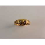 A hallmarked 18ct yellow gold ruby and diamond double heart ring, ring size M.