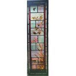 A stained glass window panel with butterfly bird and fish scene 27,5 cm 97,5 cm.