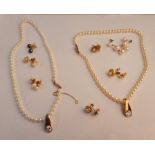 A string of pearls stamped 585 and gem stone pendant, along with a string of pearls stamped 9ct on