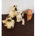 A collection of Royal Doulton animal figures rabbit, pig, and cats.
