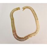 An open metalwork link necklet, stamped 750, approx. length 41cm.