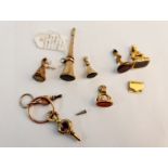 A collection of seal fobs a propelling pencil and two pocket watch keys