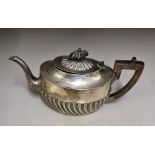 A Sheffield hallmarked silver small teapot with wood handle and finial. Total weight 224grams