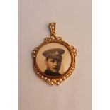 A seed pearl photo pendant, stamped on loop 9ct.