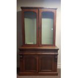 A 19th century mahogany glazed topped bookcase with cupboard base.